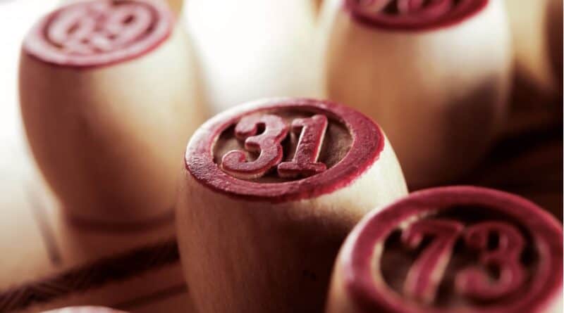 Close-up of numbered wooden chips, with the number 31 prominently displayed in focus.