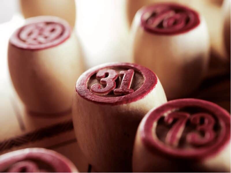 Close-up of numbered wooden chips, with the number 31 prominently displayed in focus.